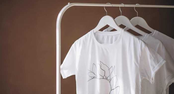 White shirts hanging isolated in room