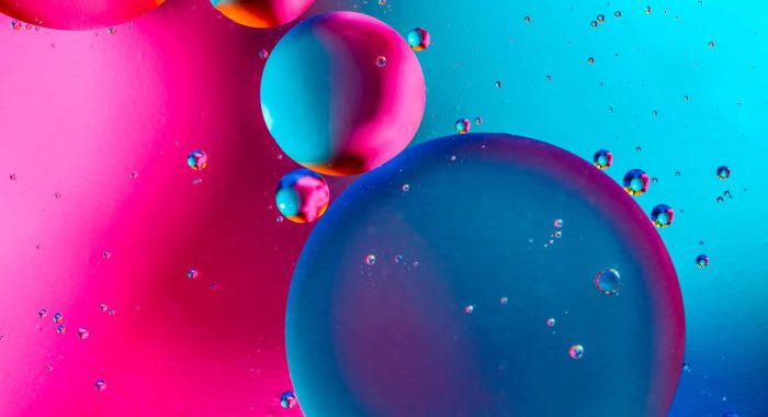 Abstract background with colorful pink blue gradient colors. Oil drops in water abstract psychedelic pattern image