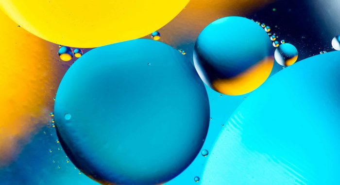 Beautiful color abstract background from mixied water and oil. Pastel colored abstraction. Orange, blue and yellow background from water bubbles