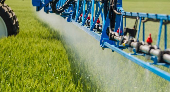Agricultural sprayers, spray chemicals on young wheat.
spraying pesticides on wheat field with sprayer