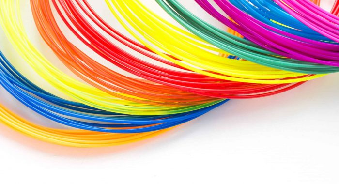 Colorful rainbow plastic filaments for 3D pen laying on white background. New toy for child. 3d paintings and figures with their own hands.