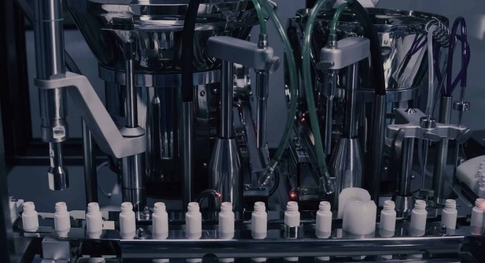 Drug Production. Medical vials on pharmaceutical manufacturing line. Medical ampoules on automated production line at factory. Process of production of pills, tablets. Pharmaceutical industry