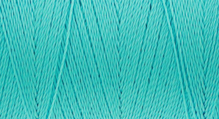 Macro picture of sew thread texture green turquoise color surface background