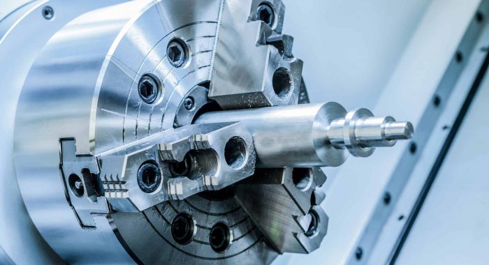 Chuck lathe closeup. Toned image in the cold industrial color.Shallow depth of field.