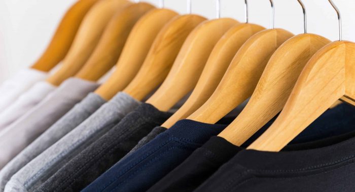 Close up of T-shirts on hangers, apparel background