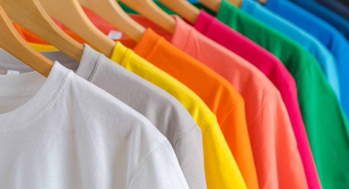 Close up of Colorful t-shirts on hangers, apparel background
