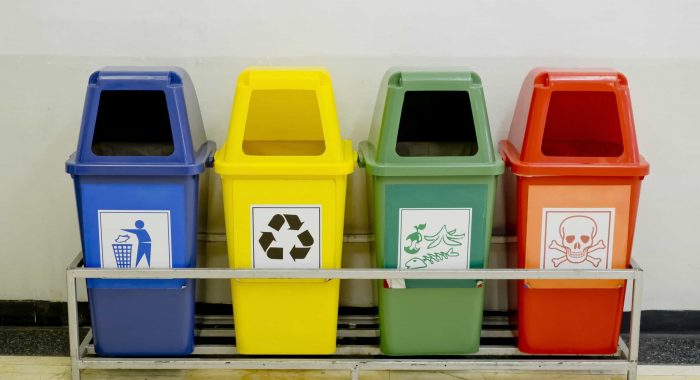 Different Colored wheelie bins set with waste icon