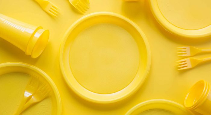 Yellow disposable picnic utensils. Environment , eco friendly discarded, plastic, garbage, collection for recycle.Top view. Flat lay. Save planet. Copy space