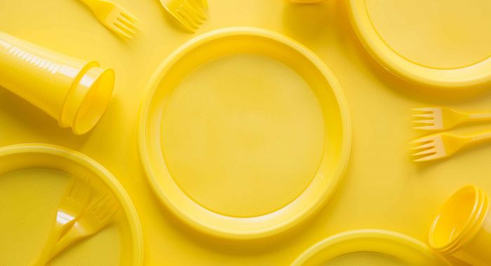 Yellow disposable picnic utensils. Environment , eco friendly discarded, plastic, garbage, collection for recycle.Top view. Flat lay. Save planet. Copy space