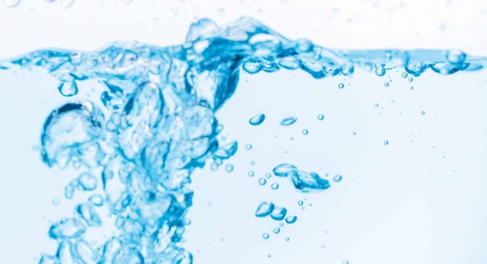 Surface of the blue water waves splash on a white background