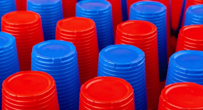 Plenty of plastic empty colorful cups close up