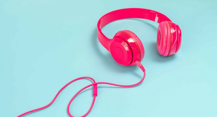 pink headphone isolate on blue background.