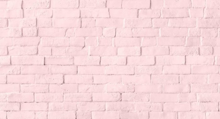 Pastel pink brick wall textured background