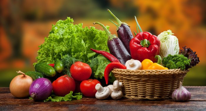 organic food background Vegetables in the basket. On a wooden table
